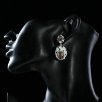 Side angle view of KHAISTA oval crystal pave drop earrings