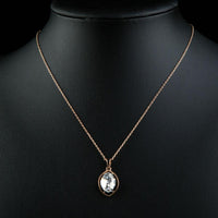 Close up detail of KHAISTA oval crystal pendant necklace