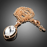 Side angle view of KHAISTA oval crystal pendant necklace