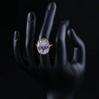 Side angle view highlighting the comfortable band silhouette of the luxury oval crystal solitaire ring