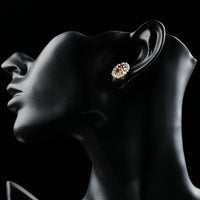 Close up of KHAISTA oval flower stud earrings