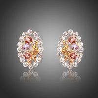 KHAISTA oval flower stud earrings on white background