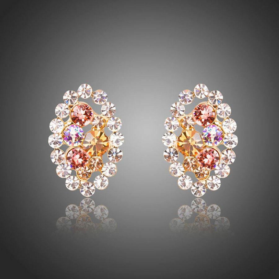 KHAISTA oval flower stud earrings on white background