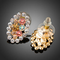Side angle view of KHAISTA oval flower stud earrings