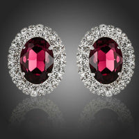KHAISTA oval maroon CZ stud earrings on white background