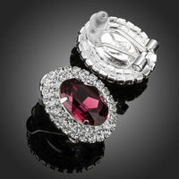 Close up of KHAISTA oval maroon CZ stud earrings