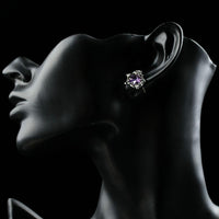 Close up of KHAISTA oval purple CZ stud earrings