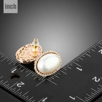 oval shell pearl stud earrings detail view by KHAISTA