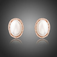 KHAISTA oval shell pearl stud earrings on white background