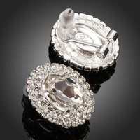 Close up of KHAISTA oval silver CZ stud earrings