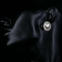 Side angle view of KHAISTA oval silver CZ stud earrings