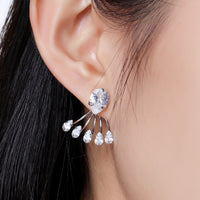 Close up of KHAISTA crystal paw design drop earrings