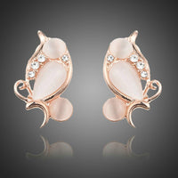 KHAISTA peach crystal clip earrings on white background