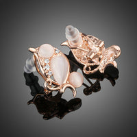 Close up of KHAISTA peach crystal clip earrings