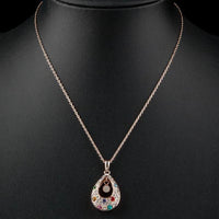 Close up detail of KHAISTA peacock tears crystal pendant necklace