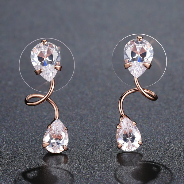 KHAISTA pear cut CZ drop earrings on white background