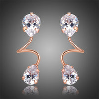 Side angle view of KHAISTA pear cut CZ drop earrings