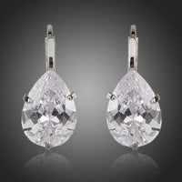 KHAISTA pear shaped CZ drop earrings on white background