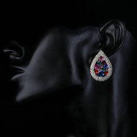Side angle view of KHAISTA pear shaped CZ stud earrings