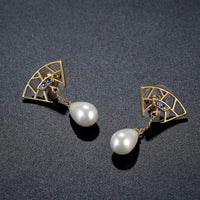 Close up of KHAISTA pearl cubic zirconia drop earrings