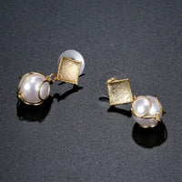 Close up of KHAISTA pearl drop earrings for women