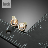 Close up of KHAISTA pearl eyeball stud earrings