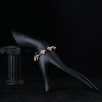Side angle view of KHAISTA pearl flower crystal bracelet