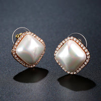Close up of KHAISTA pearl geometric stud earrings