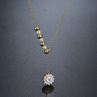 Pendant detail on KHAISTA pearl sunflower pendant necklace