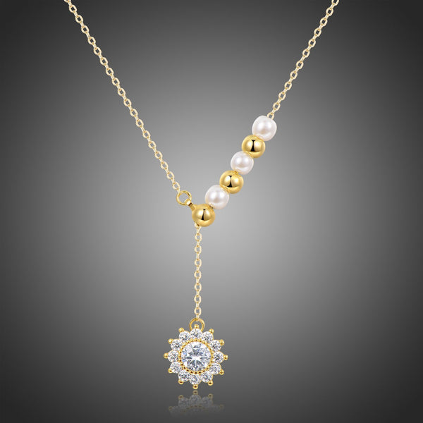 KHAISTA pearl sunflower pendant necklace on white background