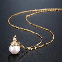 Close up detail of KHAISTA pearl round cut CZ pendant necklace