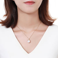 Side angle view of KHAISTA pearl round cut CZ pendant necklace