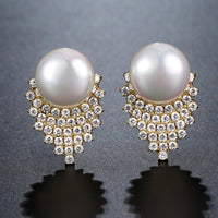 Close up of KHAISTA pearl stud earrings for women