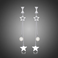 KHAISTA clear CZ pearl pentagram drop earrings on white background