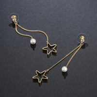 Side angle view of KHAISTA pentagram crystal drop earrings