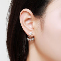 Side angle view of KHAISTA crystal pentagram stud earrings