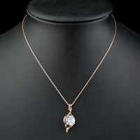 Side angle view of KHAISTA plant shape CZ pendant necklace