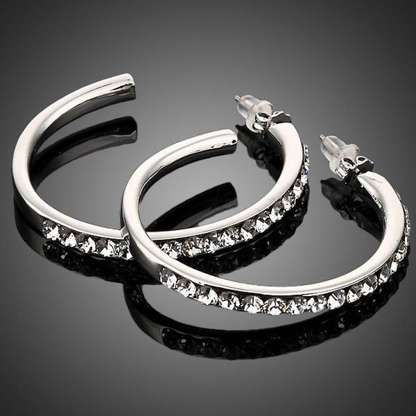 KHAISTA platinum plated bangle design drop earrings on white background