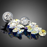 Close up of KHAISTA platinum plated crystal cluster drop earrings