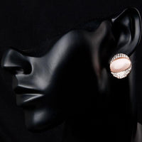 Side angle view of KHAISTA crystal popping eye stud earrings