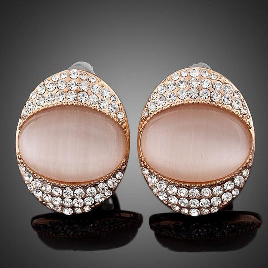 KHAISTA crystal popping eye stud earrings on white background