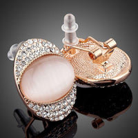 Close up of KHAISTA crystal popping eye stud earrings