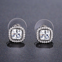 Close up of KHAISTA prong set square crystal stud earrings