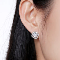 Side angle view of KHAISTA prong set square crystal stud earrings
