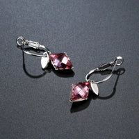 Close up of KHAISTA purple Austrian crystal drop earrings