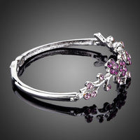 Close up detail of KHAISTA purple blossom twig bangle