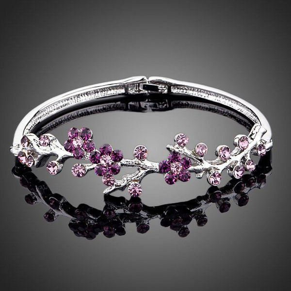 KHAISTA purple blossom twig bangle on white background