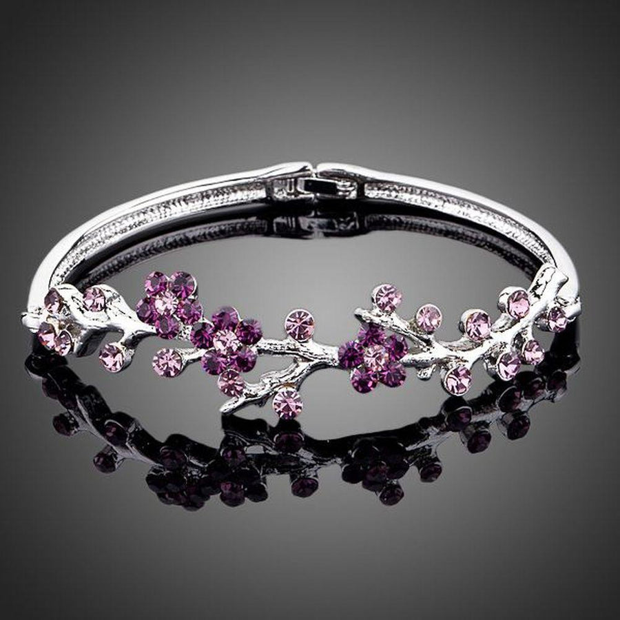 KHAISTA purple blossom twig bangle on white background