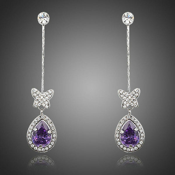 KHAISTA purple butterfly zirconia drop earrings on white background