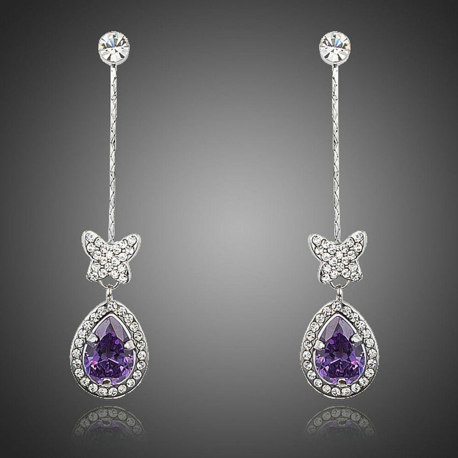 KHAISTA purple butterfly zirconia drop earrings on white background
